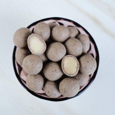 Bowl of white chocolate covered macadamia nuts with 100% Kona Coffee espresso mixed in