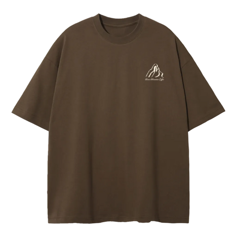 A brown short-sleeve crewneck t-shirt with a small white line-art mountain logo on the left chest, displayed on a clean white background.